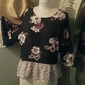 Semi sheer black floral ruffle sleeve top.